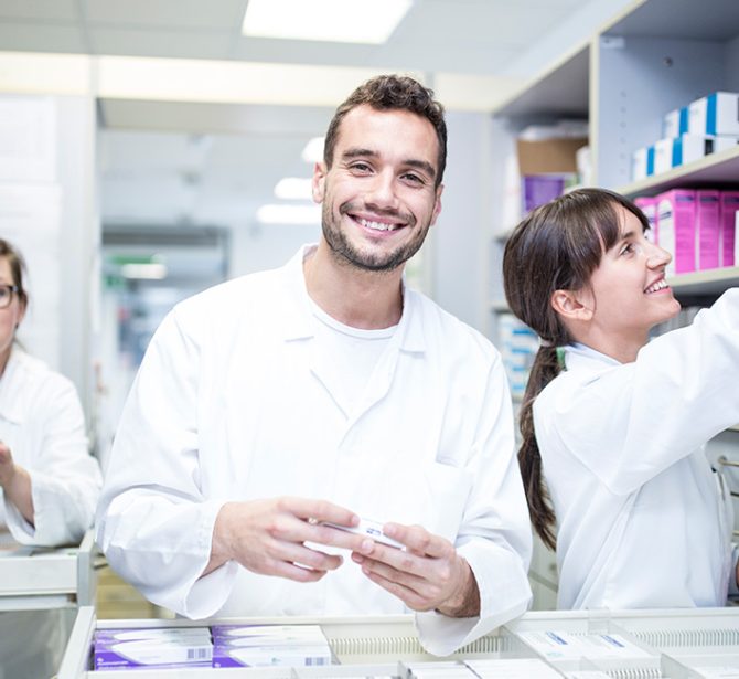 Pharmacists working together in a pharmacy, managing inventory and providing patient care.